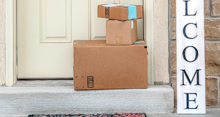 Boxes by the door of a residence with a welcome sign in Wausau